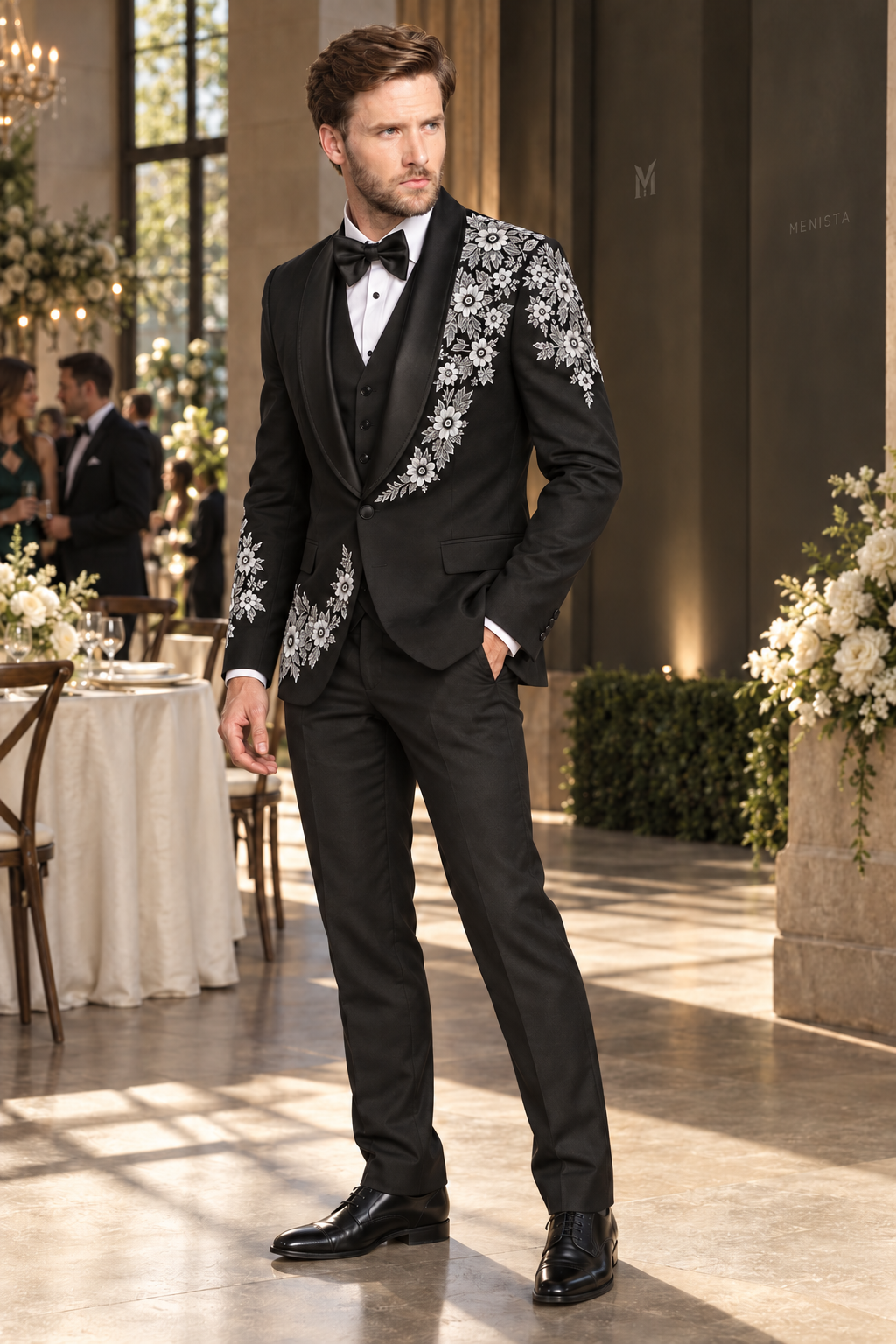 Three-quarter view of Alaric black tuxedo showing white daisy embroidery and black satin shawl lapels.