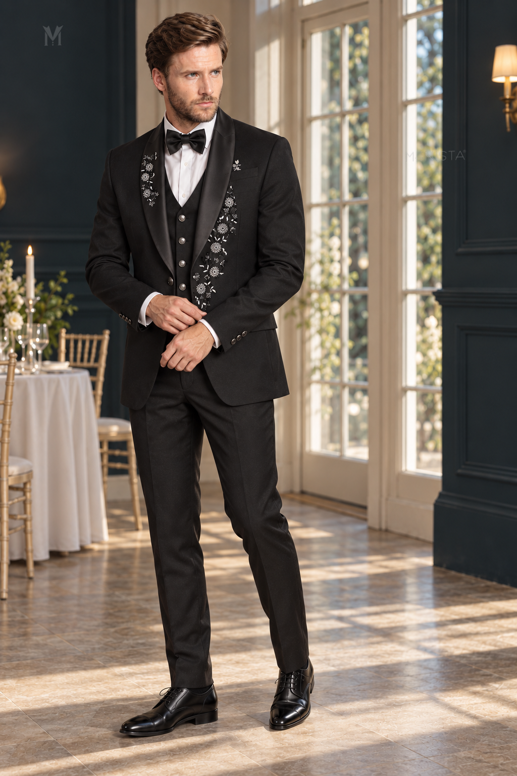 Three-quarter view of Dorian black daisy floral embroidered tuxedo with one-button jacket, simple four-button waistcoat and matching trousers.