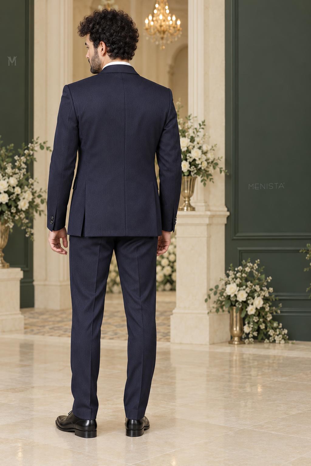 Full back view of Cassian navy tuxedo showing plain jacket back, centre seam, two side vents and matching trousers.