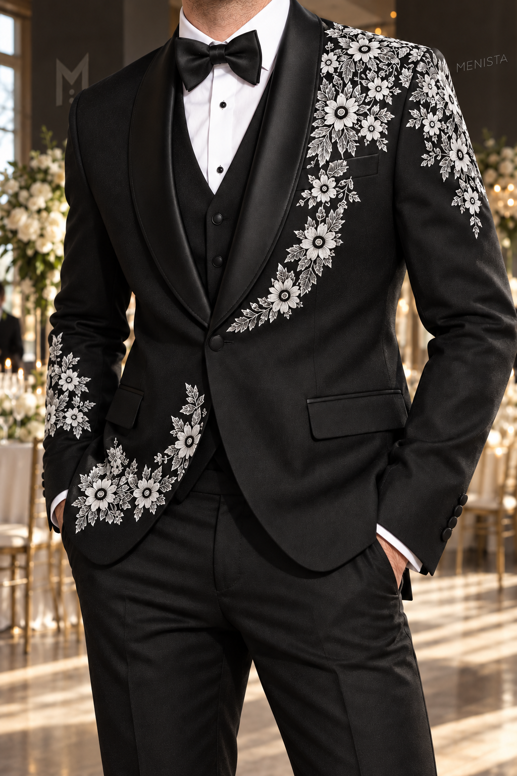 Close-up of Alaric white daisy floral embroidery, satin shawl lapels and single black jacket button.