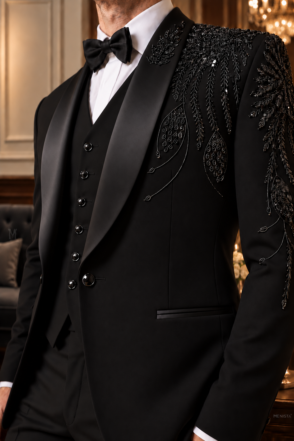 Close-up of Aurel black floral and feather-inspired bead embroidery, satin shawl lapels, single jacket button and plain waistcoat.