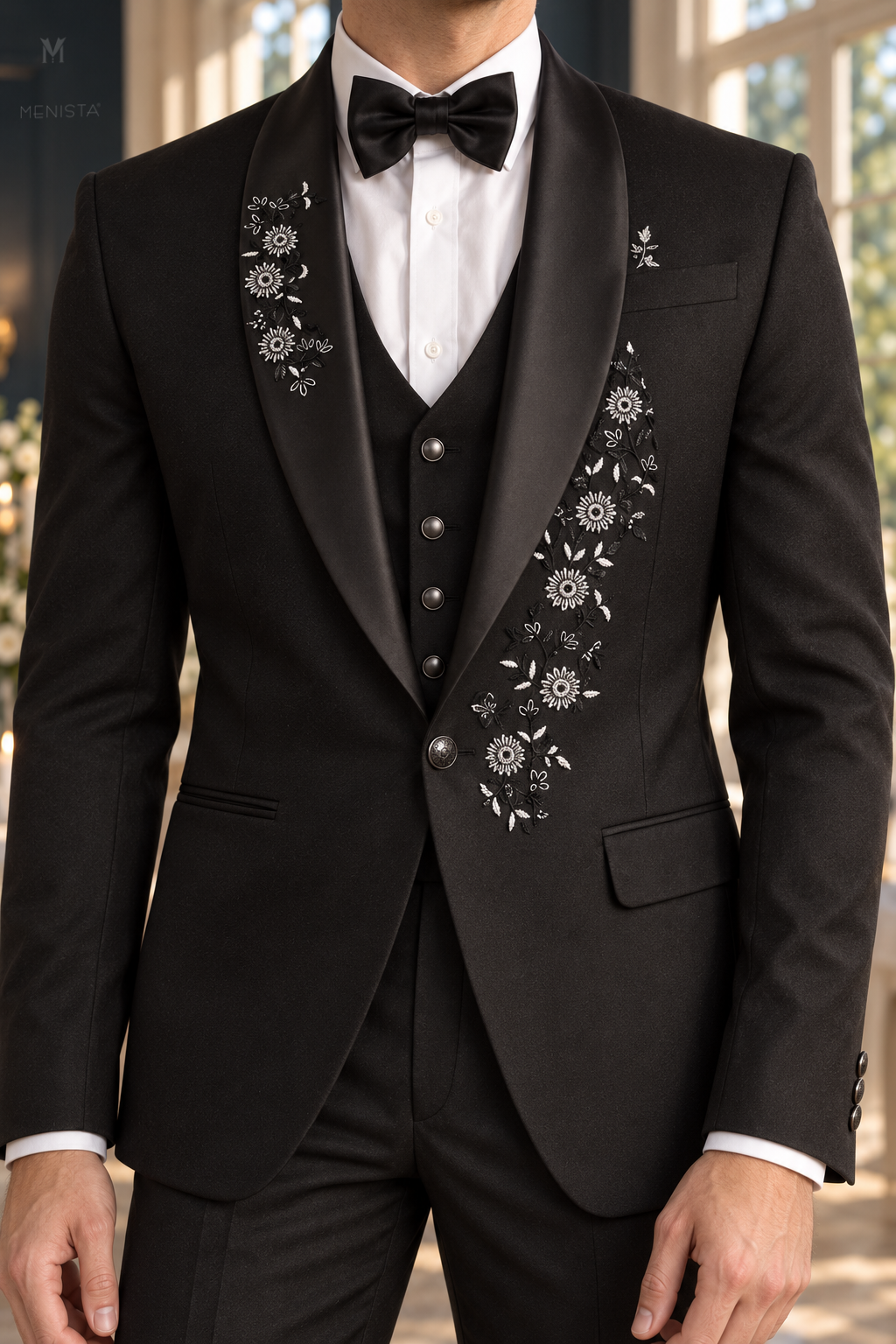 Close-up of Dorian silver daisy floral embroidery, black satin shawl lapel, breast pocket and one-button jacket.