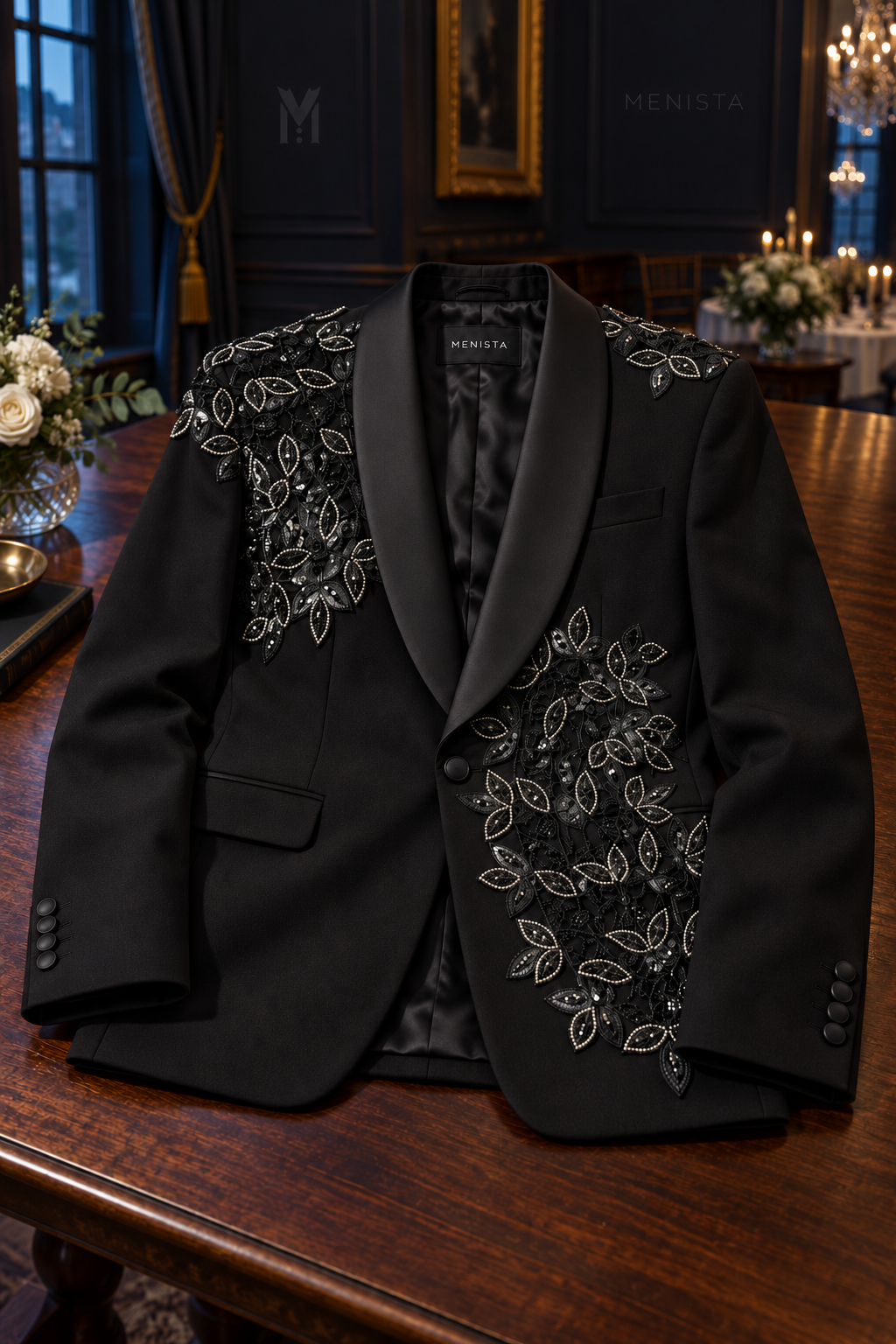 Ronan black botanical beaded jacket wholly supported on a flat flat walnut table, with one front button and two flap pockets.